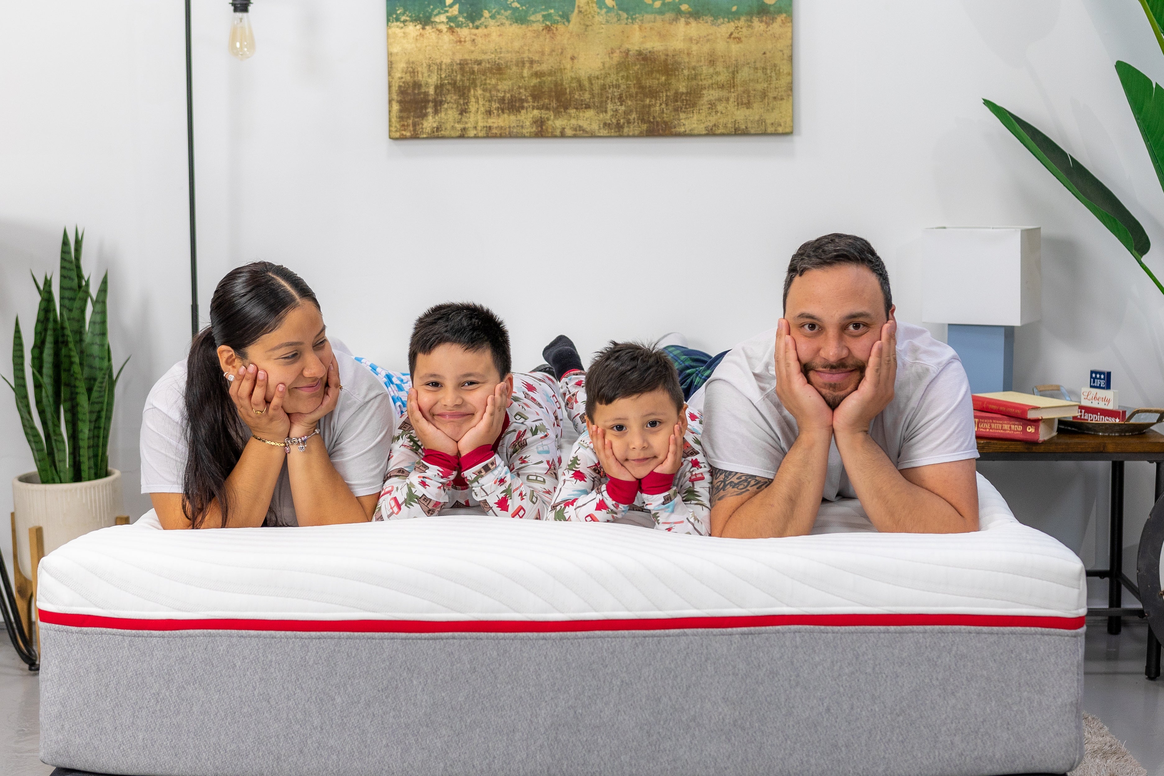 Family happily relaxing on our medium/firm Red Memory Foam Mattress - Welcome to USA Mattress Factory